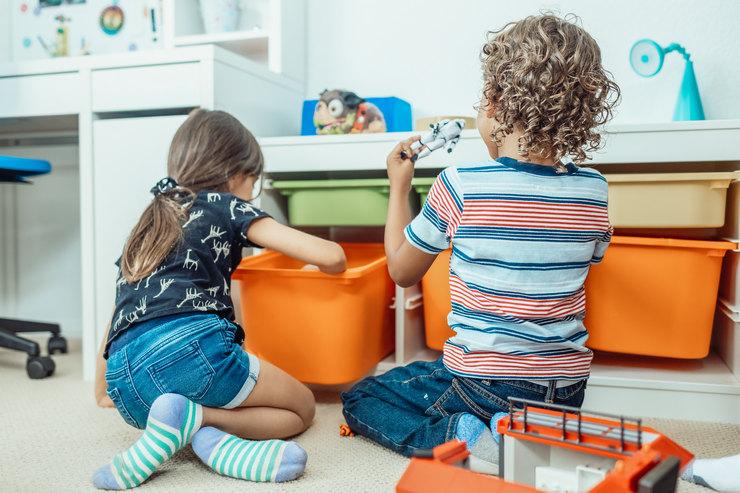 photo of 2 children playing facing back guide how to adopt a child in the uae